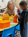 child and adult playing with sensory silicone flowers for cognitive engagement and dementia therapy